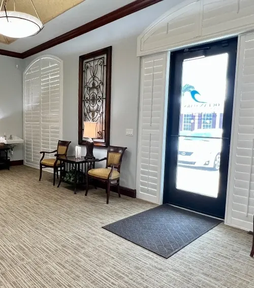 The front door and lobby, with sailing prints above the sofa.